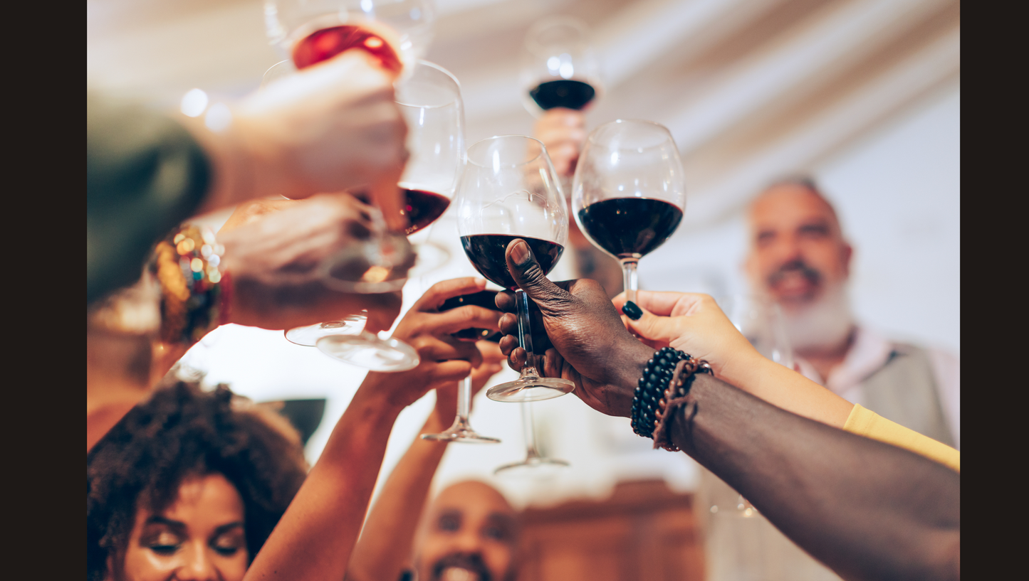 People toasting with wine glasses at a social gathering.